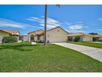 Single story home with attached garage and palm tree at 4223 Murfield E Dr, Bradenton, FL 34203
