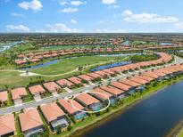 Aerial view of home with pool in a waterfront community at 25081 Spartina Dr, Venice, FL 34293