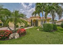 Luxury home with lush landscaping and palm trees at 198 Montelluna Dr, North Venice, FL 34275