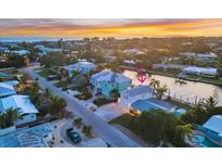 Captivating waterfront home with vibrant sunset views, lush landscaping, and convenient dock access, perfect for coastal living at 508 65Th St, Holmes Beach, FL 34217