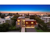Luxury beachfront home with modern architecture at sunset at 2945 Pyrula Dr, Longboat Key, FL 34228