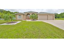 Two-story house with a three-car garage and palm trees at 17706 Bridlewood Ct, Parrish, FL 34219