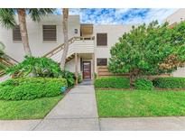 Condo building exterior with lush landscaping and a walkway at 184 Pineneedle Dr # 184, Bradenton, FL 34210