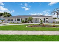 Updated ranch-style home with new landscaping and driveway at 353 Suwanee Ave, Sarasota, FL 34243