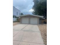 Two-car garage and light-colored house exterior with landscaping at 1928 9Th St, Sarasota, FL 34236