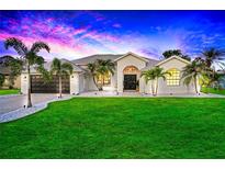 Single-story home with a landscaped yard at sunset at 158 Allworthy St, Port Charlotte, FL 33954