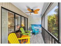Enjoy outdoor living on this patio featuring colorful Adirondack chairs and a tranquil mural backdrop at 3705 E Bay Dr # 115, Holmes Beach, FL 34217
