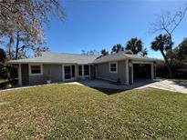 Single story home with gray siding and attached garage at 700 Dolphin Rd, Venice, FL 34293