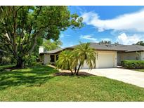 Front view of a house with lush landscaping at 7301 Ballantrae Pl # 27D, Sarasota, FL 34238