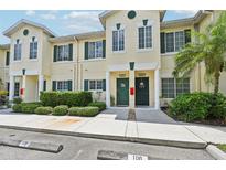 Two-story townhouses with green doors and landscaping at 341 Cape Harbour Loop # 105, Bradenton, FL 34212