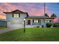 Charming two-story home boasting a manicured lawn and attached garage at 5111 Coral Blvd, Bradenton, FL 34210