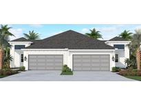 Two-car garage home with gray garage doors and white exterior at 11671 Great Brook Ln, Parrish, FL 34219