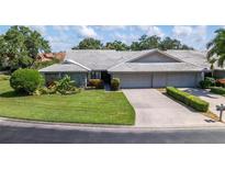 Two-story house with a tile roof and attached two-car garage at 3851 Wilshire Dr # 9, Sarasota, FL 34238