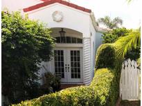Charming home with white exterior, red tile roof, and lush landscaping at 2107 89Th St Nw, Bradenton, FL 34209