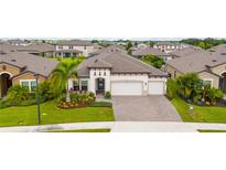 Aerial view of a single-Gathering home with landscaped yard and two-car garage at 8933 Isabella Cir, Parrish, FL 34219