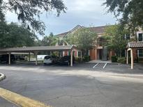 Condo building with covered parking and landscaping at 4102 Central Sarasota Pkwy # 922, Sarasota, FL 34238