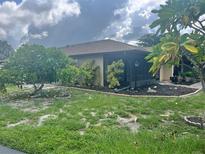 Condo with a screened porch and landscaped yard at 4210 66Th Street W Cir, Bradenton, FL 34209
