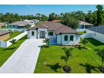 Single-story home with a modern design and landscaping at 5494 Mojave Ave, North Port, FL 34288