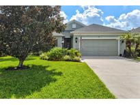 Single-Gathering home with two-car garage, landscaping, and curb appeal at 4529 Golden Gate Cv, Bradenton, FL 34211