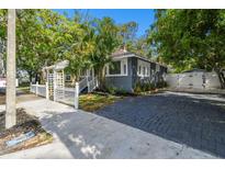 Gray house with white fence and paver driveway at 1611 Ballard Park Dr, Bradenton, FL 34205