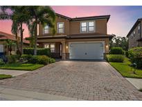 Two-story house with brick paver driveway and landscaping at 1048 Bradberry Dr, Nokomis, FL 34275