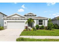 Charming one-story house with gray exterior and stone accents at 12665 Promenade Estates Blvd, Sarasota, FL 34238