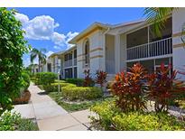 Condo building with lush landscaping and walkways at 6904 Drewrys Blf # 803, Bradenton, FL 34203