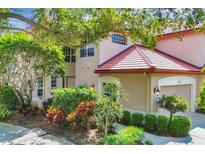 Two-story home with red tile roof and lush landscaping at 7365 Regina Royale Blvd # 10, Sarasota, FL 34238