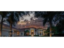 Luxury home exterior at dusk with fountain and landscaping at 3218 Signet Ct, Sarasota, FL 34240