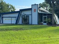 Mid-century modern home with unique architecture and landscaping at 3442 Swanee Rd, Punta Gorda, FL 33980