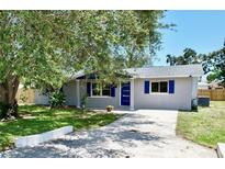 Newly renovated home with gray exterior, blue accents and landscaping at 430 Tanager Rd, Venice, FL 34293