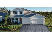 Two-story home with gray paver driveway and landscaped yard at 12681 Pinnacle Ln, Venice, FL 34293