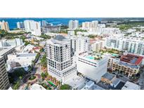Stunning aerial view of a high-rise condo building with a rooftop pool overlooking the city and ocean at 50 Central Ave # 17Phb, Sarasota, FL 34236