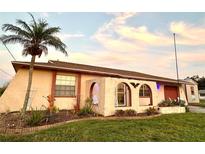 Ranch style home with landscaped yard and arched entryway at 461 Clover Rd, Venice, FL 34293