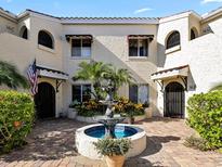 Spanish style building with courtyard fountain and lush landscaping at 6101 34Th W St # 16A, Bradenton, FL 34210