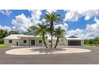 Modern home exterior with circular driveway and palm trees at 2850 Desoto Rd, Sarasota, FL 34234