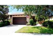 Charming single-story home featuring a brick driveway and lush landscaping at 924 Preservation St, Bradenton, FL 34208