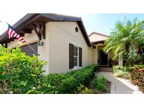 Charming home with landscaped front yard, features an American flag, and neutral-colored exterior at 924 Preservation St, Bradenton, FL 34208