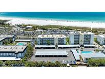 Aerial view of beachfront condominium building and surrounding area at 797 Beach Rd # 509, Sarasota, FL 34242