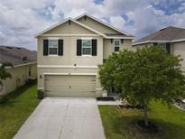 Two-story house with a light green exterior and black shutters at 4659 Lindever Ln, Palmetto, FL 34221