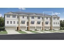 Three story townhouses with attached garages and landscaping at 9949 Key Haven Rd, Seminole, FL 33777