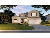 Two-story home with a white exterior, double front doors, and a two-car garage at 1876 Magnolia St, Sarasota, FL 34239
