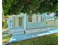 Light blue single-wide manufactured home with carport at 1806 Brook Field Ter, Sarasota, FL 34234