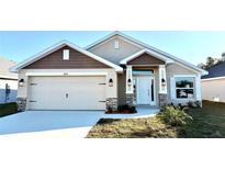 Two-story home with a neutral color palette and landscaped yard at 2624 Averland Loop, North Port, FL 34287
