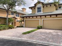 Inviting two-story home boasts a brick driveway and attached two-car garage at 6414 Moorings Point Cir # 201, Lakewood Ranch, FL 34202