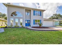 Two-story house with gray siding, blue shutters, and a well-manicured lawn at 3125 57Th Avenue E Cir, Bradenton, FL 34203