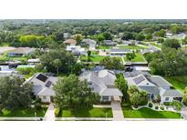 An aerial view showcases a waterfront home, surrounded by lush greenery and serene canals at 4532 Shark Dr, Bradenton, FL 34208