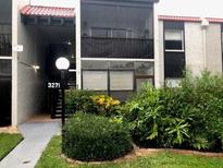 Exterior view of condo building with landscaping and walkway at 3271 Beneva Rd # 204, Sarasota, FL 34232
