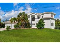 Luxury waterfront home with a large green lawn at 4323 Rock Creek Dr, Port Charlotte, FL 33948
