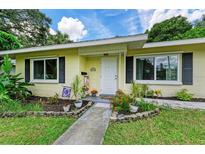 Charming yellow house with a landscaped yard and walkway at 1410 21St W St, Bradenton, FL 34205